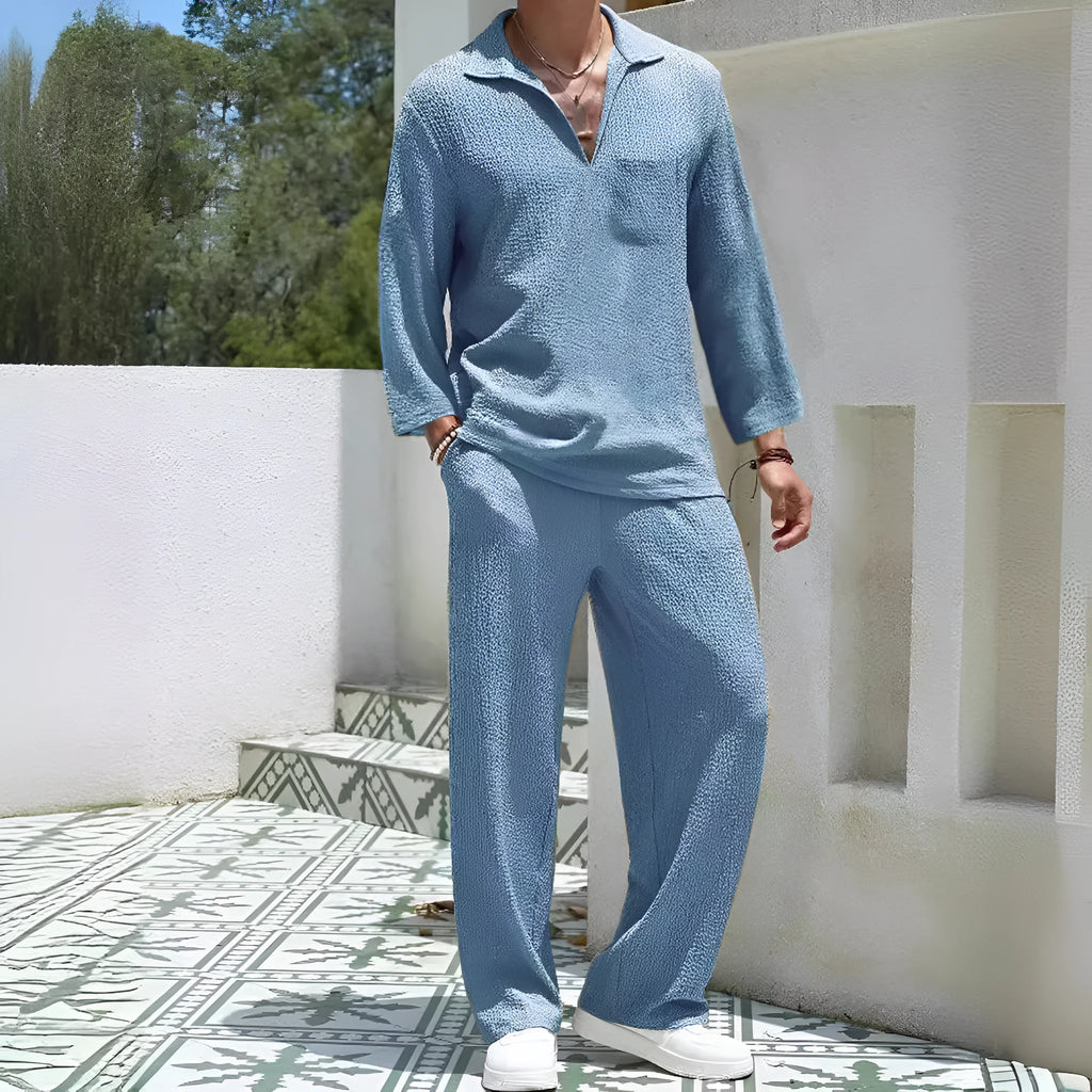 Man wearing a casual lake blue shirt jacket and matching trousers from a polyester commuter suit set.