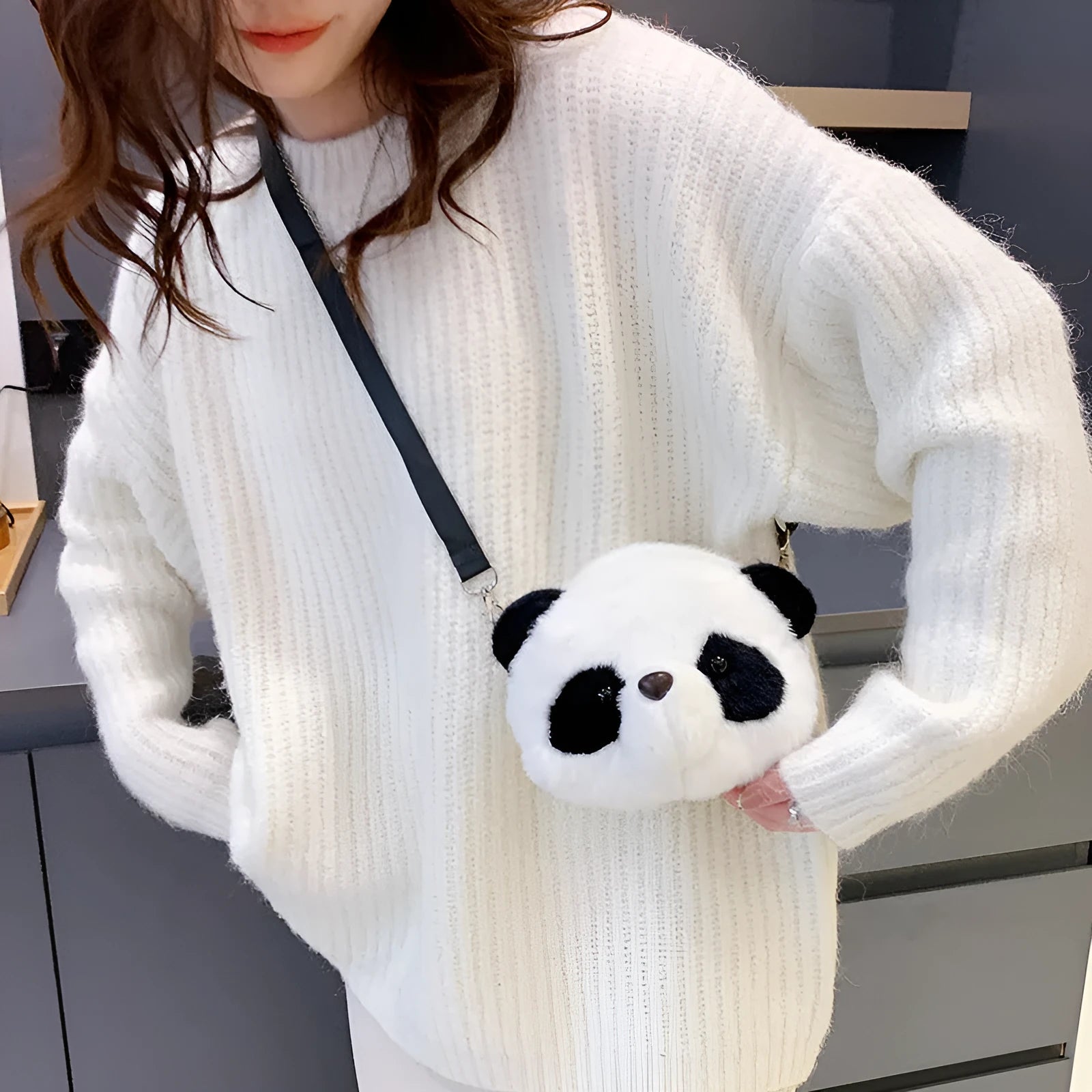 Soft plush panda head design crossbody bag in cylindrical shape on a white background.