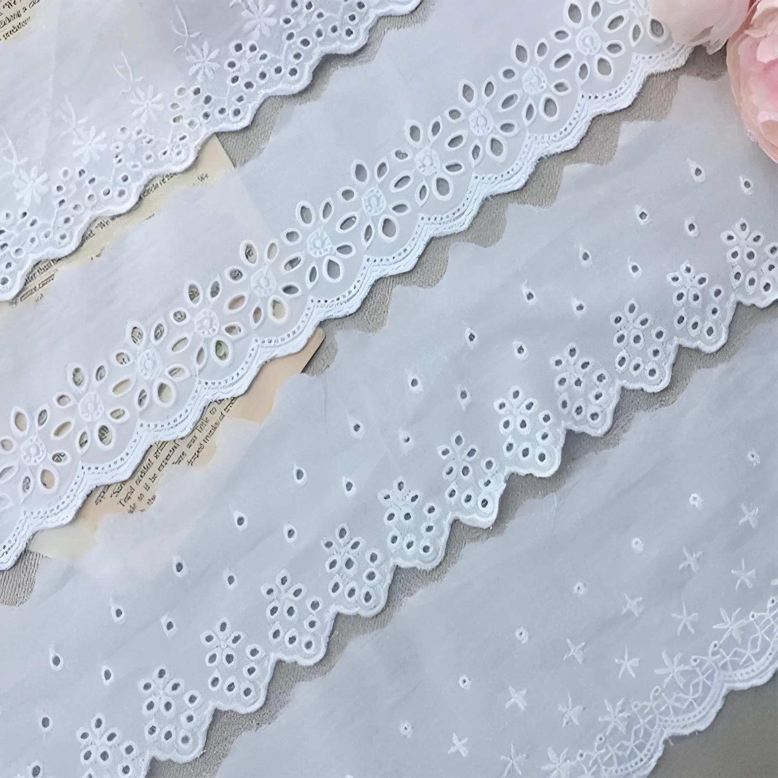 Cotton embroidered lace trim roll showing four different openwork pattern styles for DIY clothing