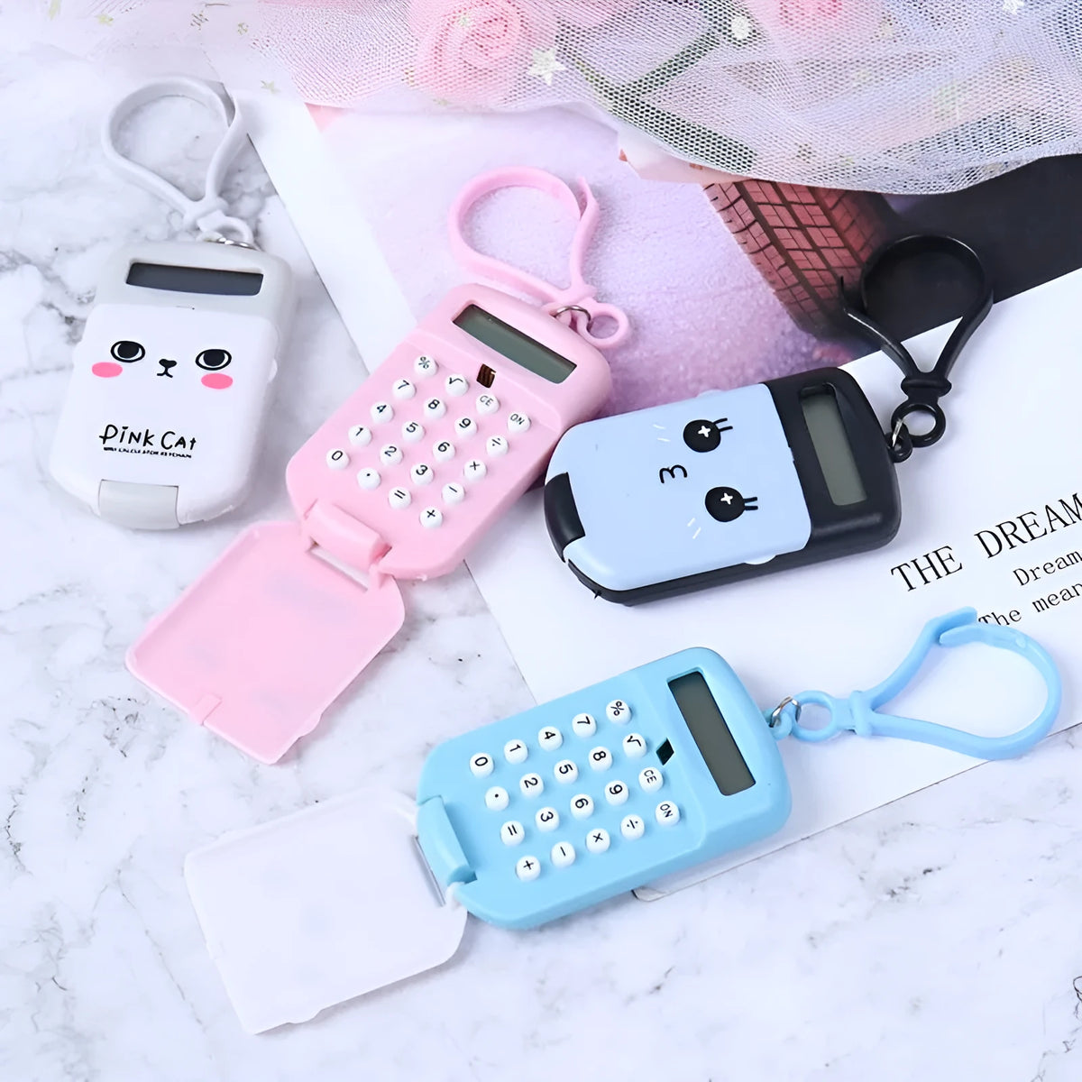 Cookie-shaped mini calculator with key ring in pink, blue, grey, or black, 6.4 x 3.6 x 11.2 cm plastic body