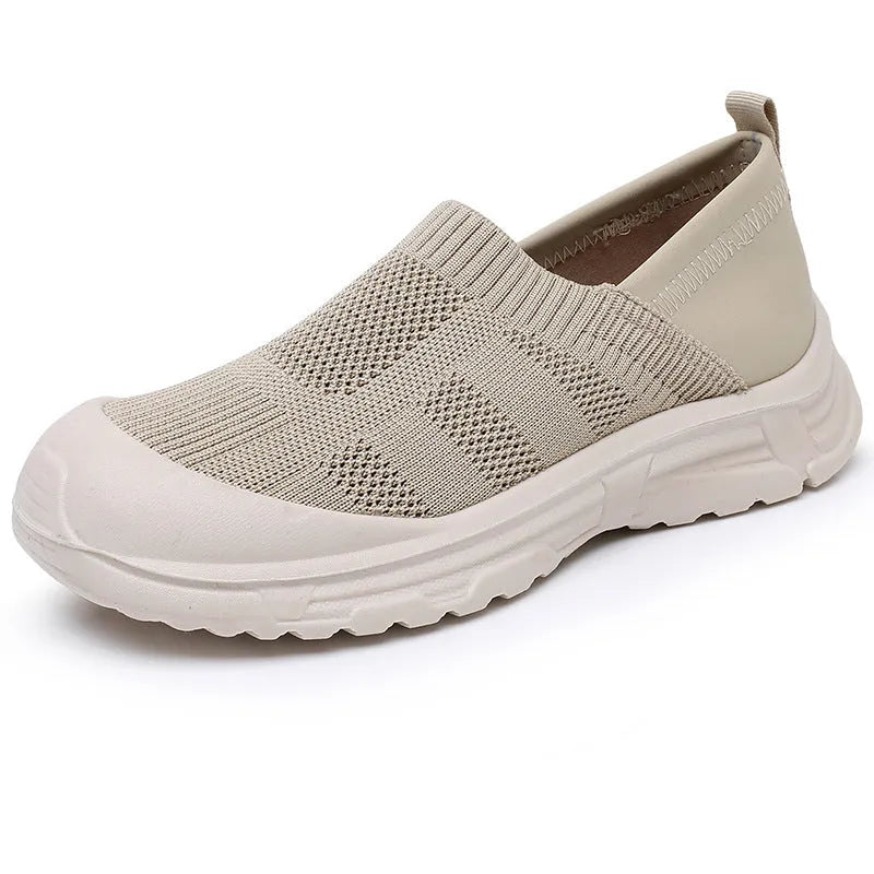 Women's black slip-on shoe with a cloth upper and soft PVC sole on a white background