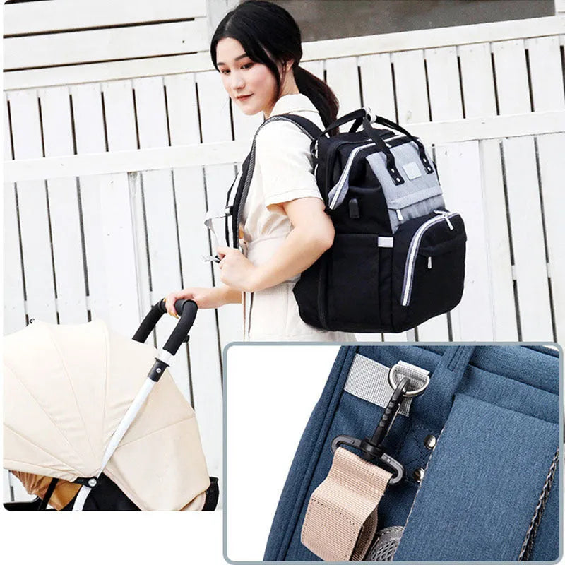 Upgraded multifunctional maternity diaper backpack in black with foldable portable crib and large capacity