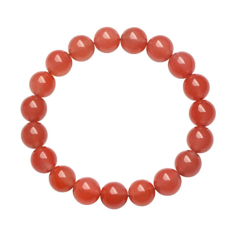 Natural cherry red agate beaded bracelet with adjustable metal clasp on a wrist, showing scattered polished stones.