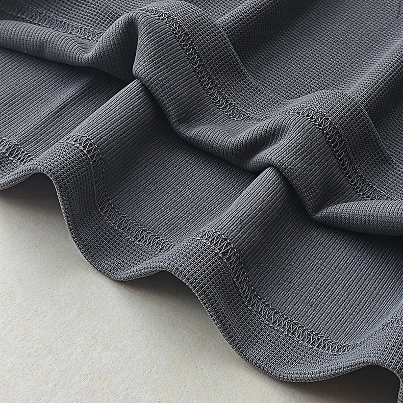 Men's dark grey heavyweight waffle knit short-sleeved T-shirt on a hanger.