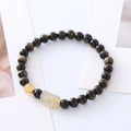 Handcrafted natural obsidian Pi Xiu bracelet with gold and red design on wrist