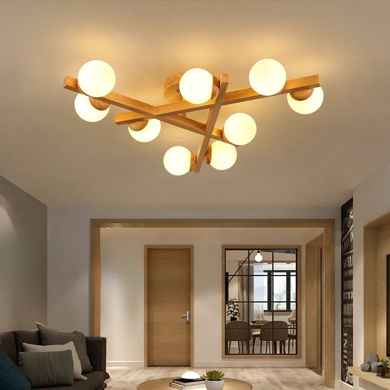 Modern Nordic-style ceiling light with wooden accents and three white lamp heads mounted on a clean, white ceiling.