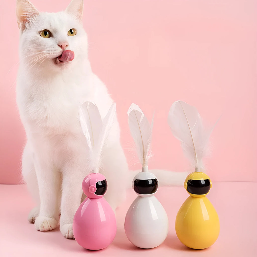 ABS tumbler cat toy with feather attachment in white colour, on a flat surface