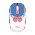 Pink Sailor Moon cartoon wireless mouse on a desk next to a laptop.