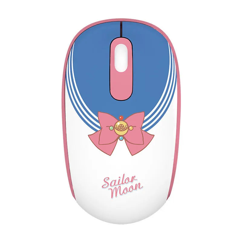 Pink Sailor Moon cartoon wireless mouse on a desk next to a laptop.