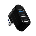Black and white USB 3.0 four-port rotary hub on a desk next to a laptop