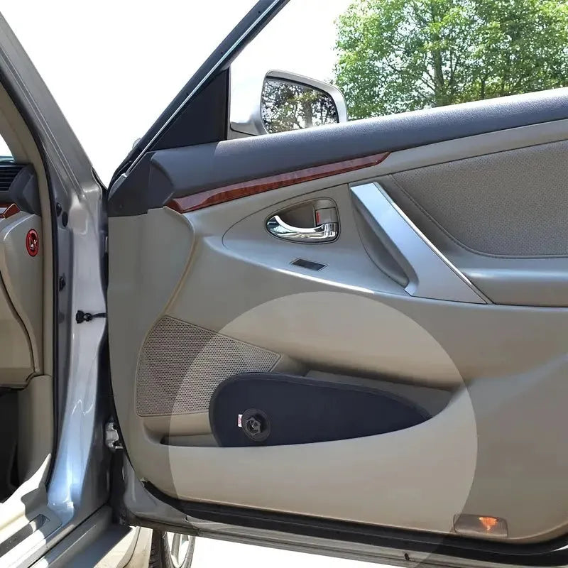 Black stretchy car side window sunshade fitted on a car door, showing suction cups and mesh fabric.