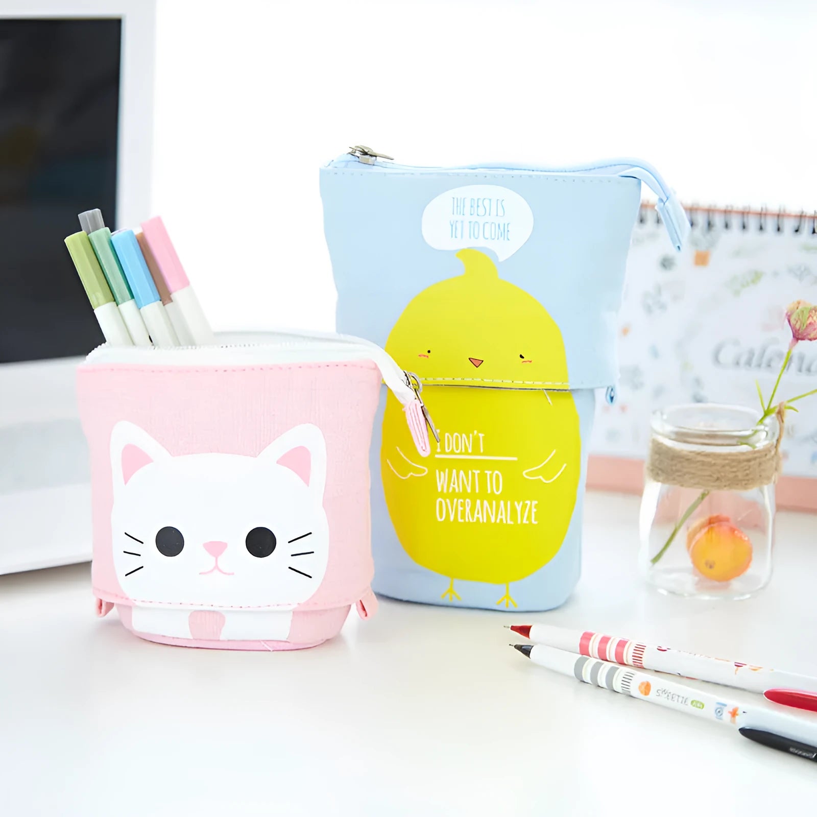 Round Korean-style canvas pencil bag with cartoon pattern, shown with pens inside.