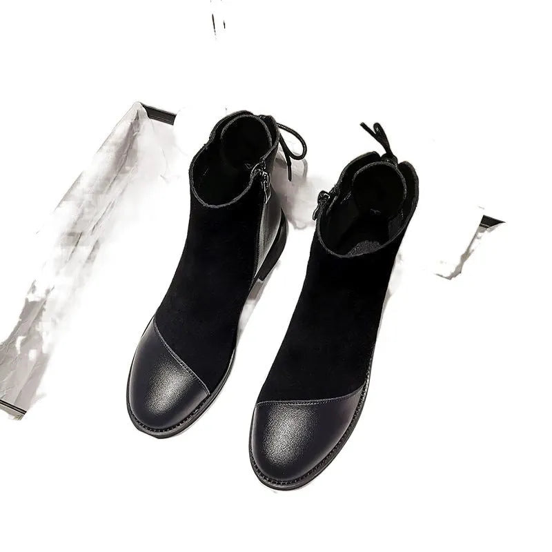 Black women's knee-high Martin boots with a side zip and decorative bow.