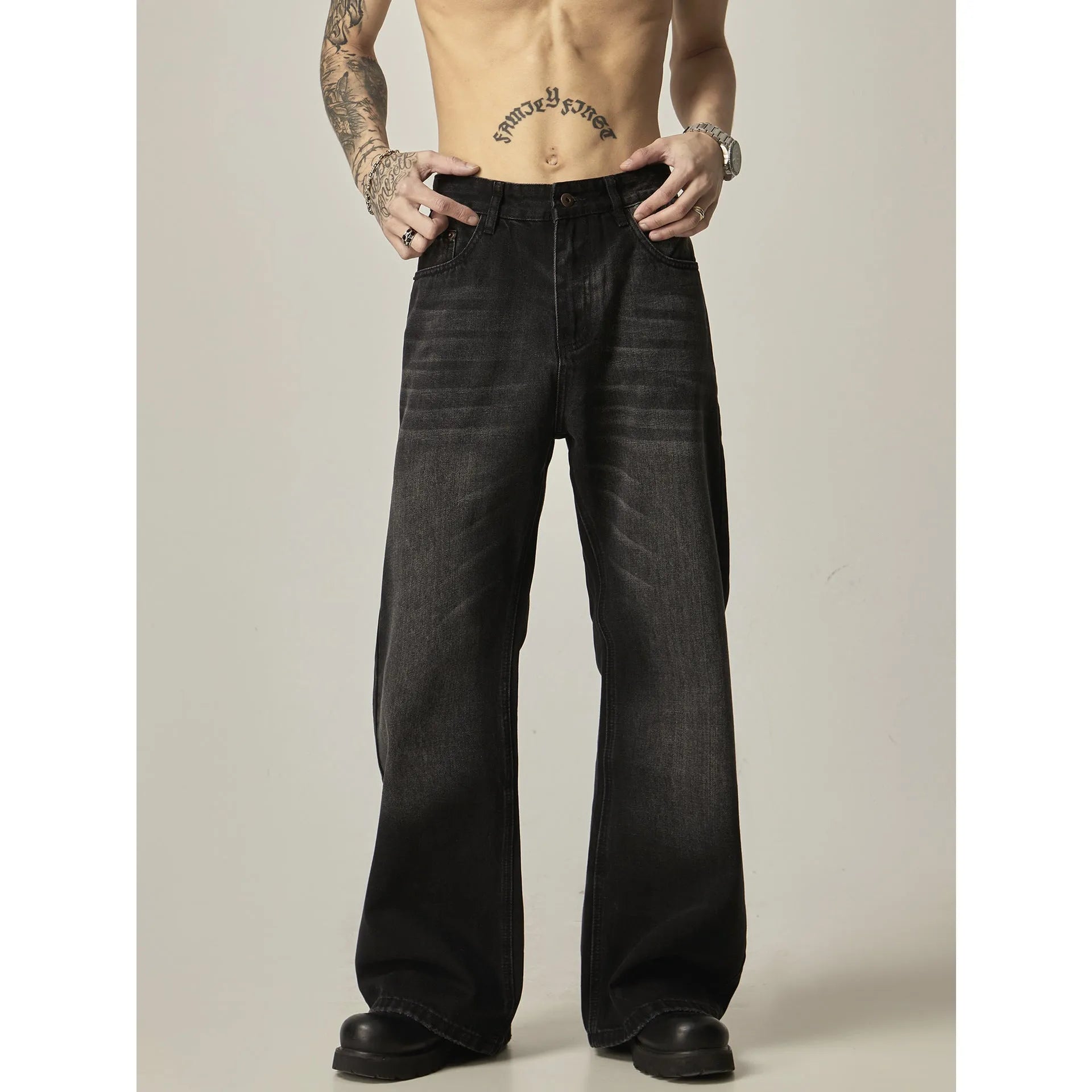 Black straight-leg jeans with retro styling and loose fit on man