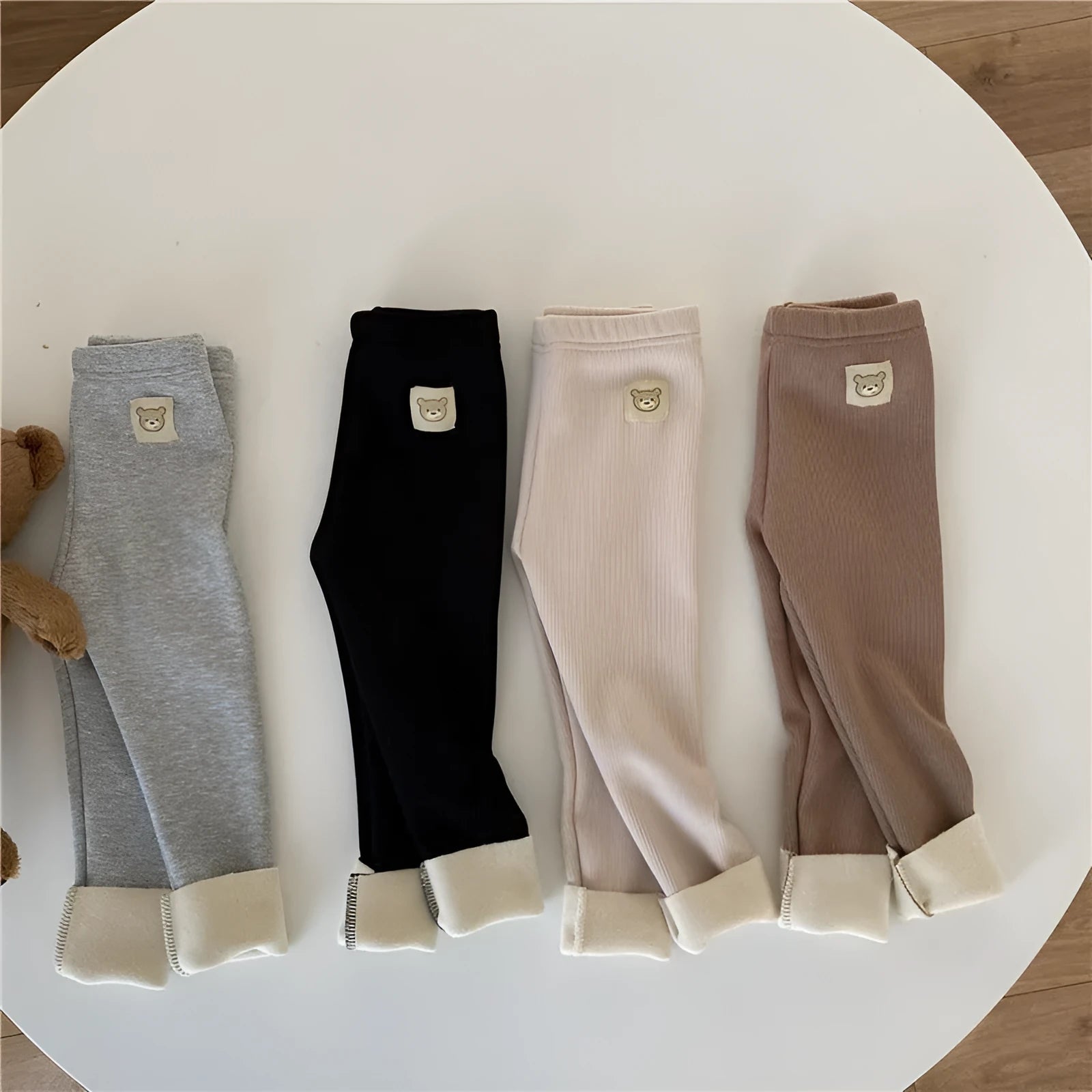 Girls' high-waist fleece-lined leggings in beige, black, brown, and grey colours on a size chart.