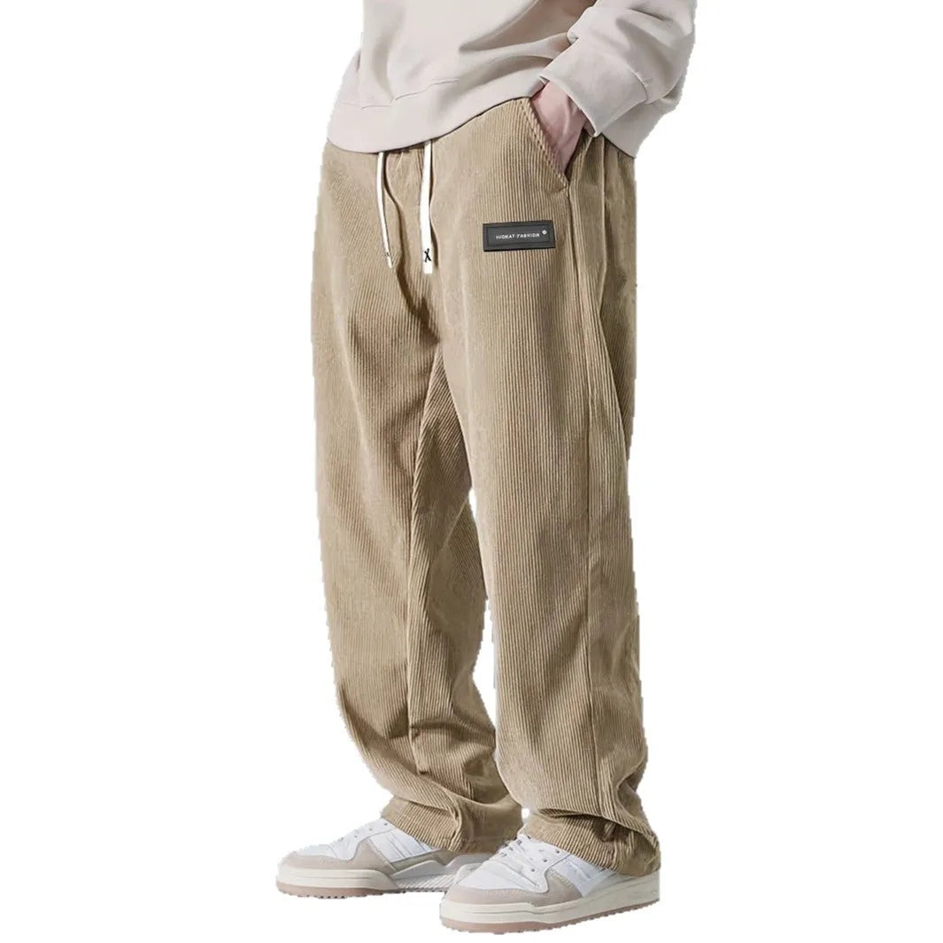 Men's straight leg corduroy trousers in khaki, drawstring waist, mid rise, polyester fabric, side view on model