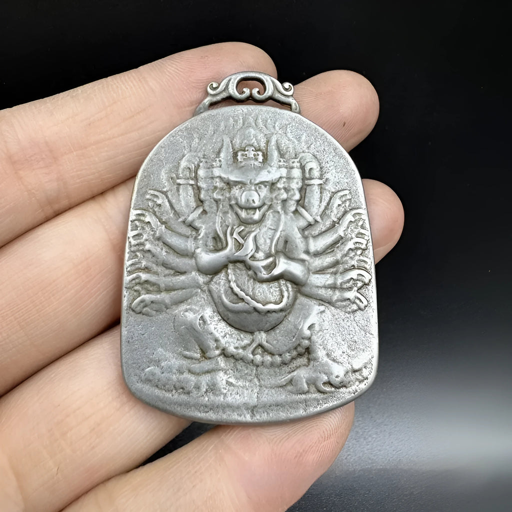 Close-up of a Chinese geometric style cast iron pendant ornament with an antique finish.