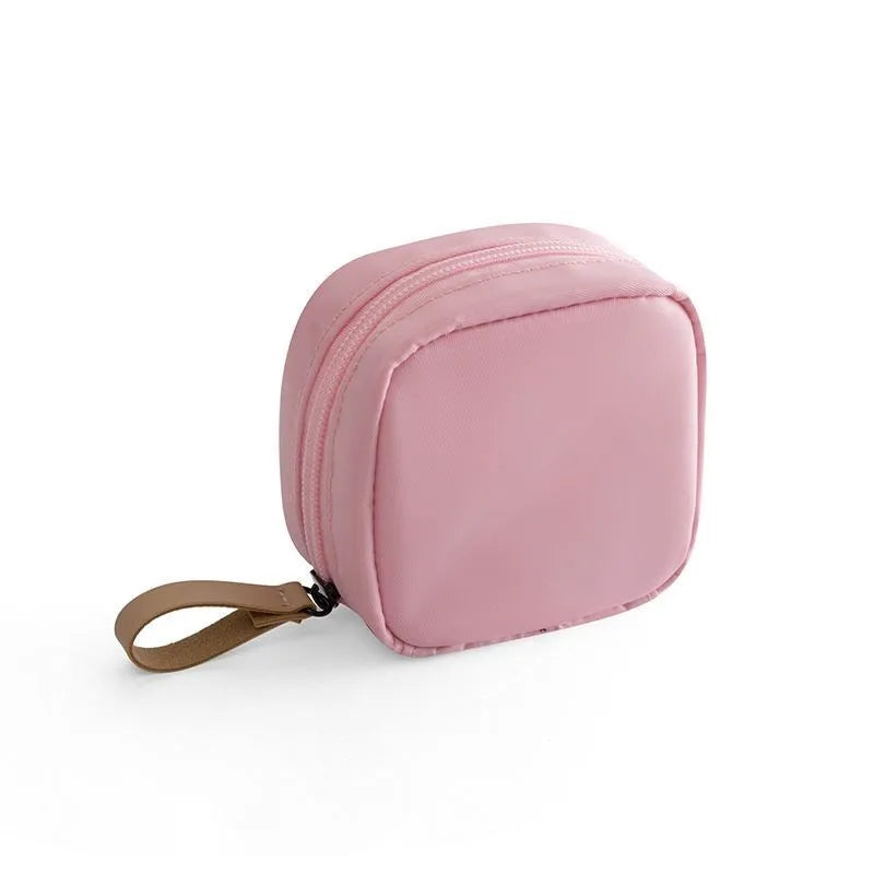 Blue cloth cube-shaped makeup storage bag with a plain pattern on a white background.