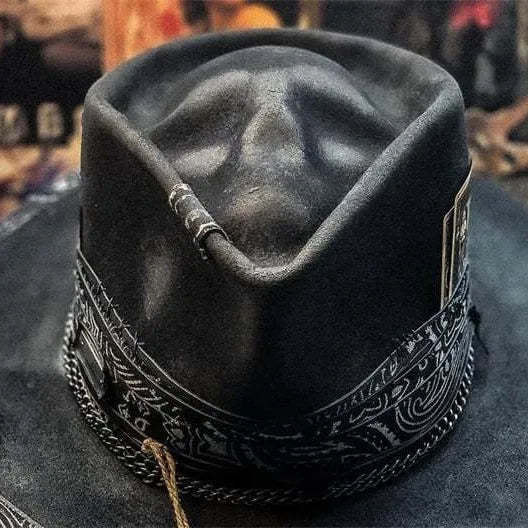 Handmade conical skull hat in wool felt and denim, shown from the side, highlighting its structured crown shape.
