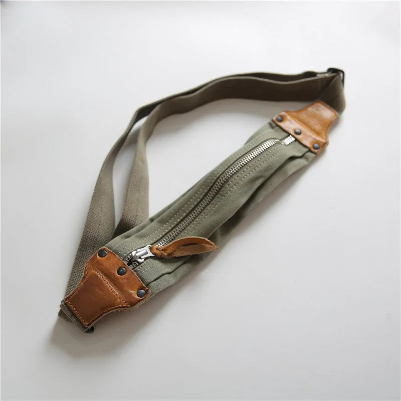 Green military style chest bag made from canvas with leather accents and adjustable shoulder straps