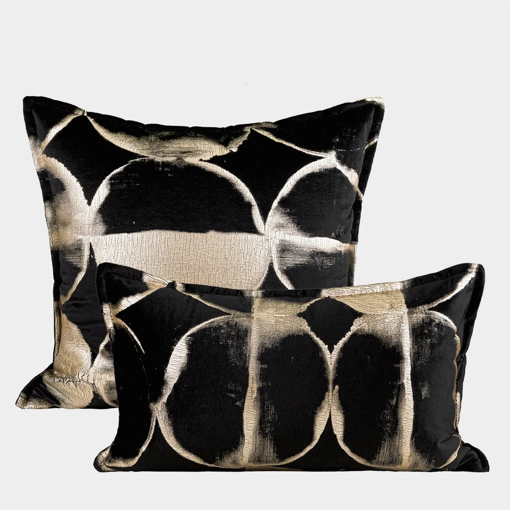 Black and gold abstract full moon pattern flannel cushion on a grey sofa
