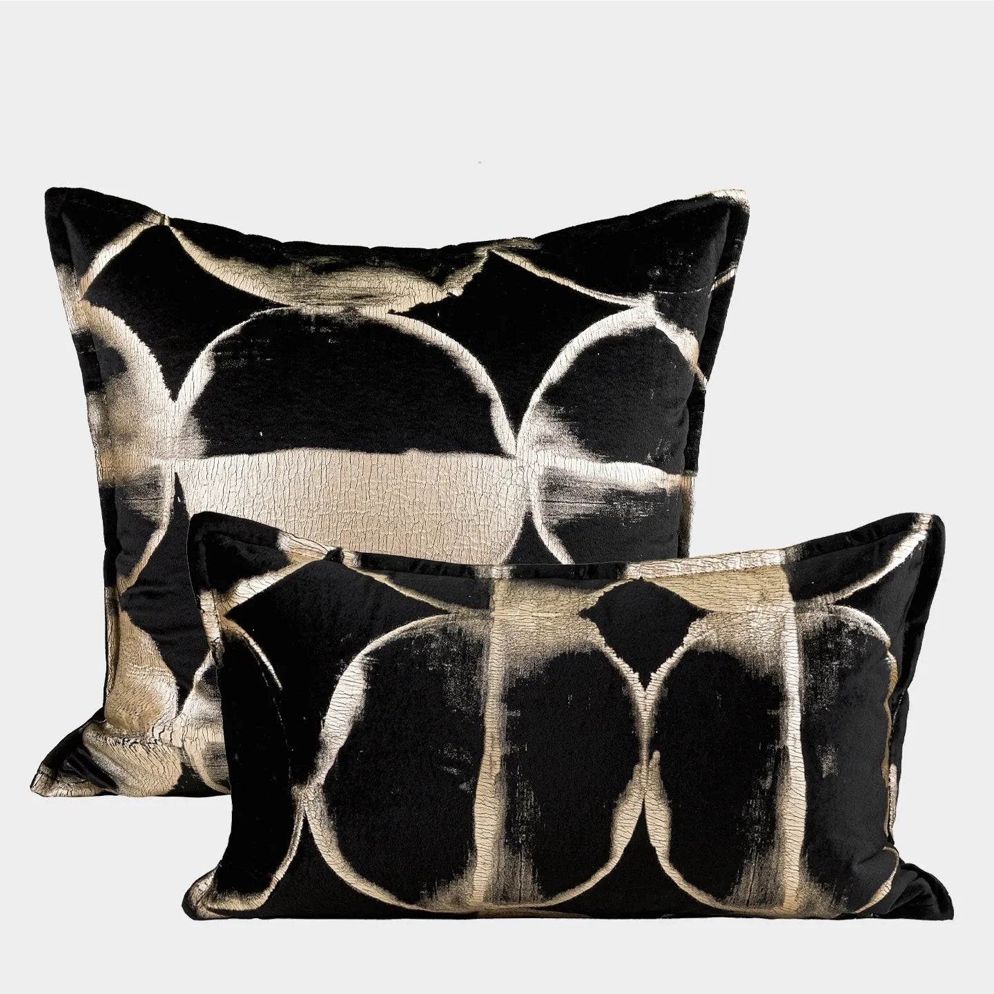 Black and gold abstract full moon pattern flannel cushion on a grey sofa
