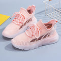 Women's white cowhide leather sports casual shoes with flat heel and round toe on a light background.
