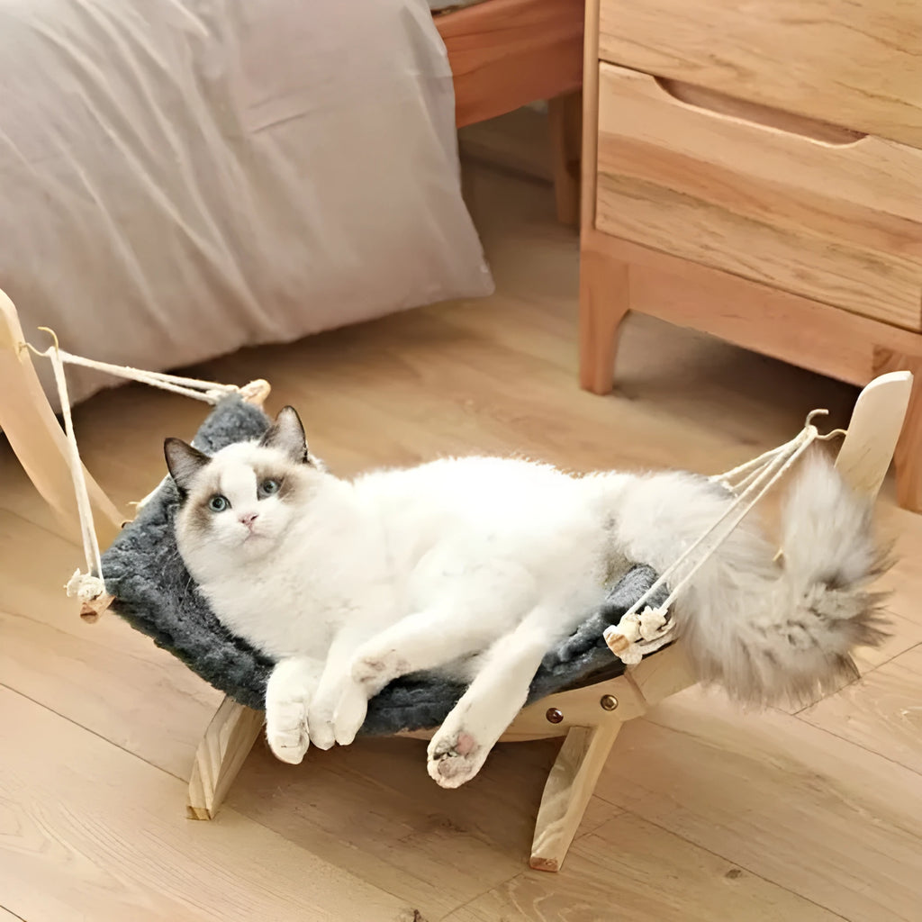 Grey solid wood cat hammock with canvas and velvet sleeping surface, hanging in a room
