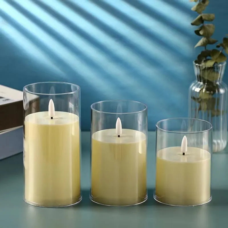 Set of three LED simulation candle lamps with cup shade in ivory white on a shelf