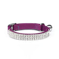 Red velvet adjustable cat collar on a table, showing buckle and 1cm width, length adjustable from 20 to 30 centimetres.