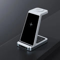 X2 three-in-one wireless charger in black charging a phone, watch, and earbuds on a desk