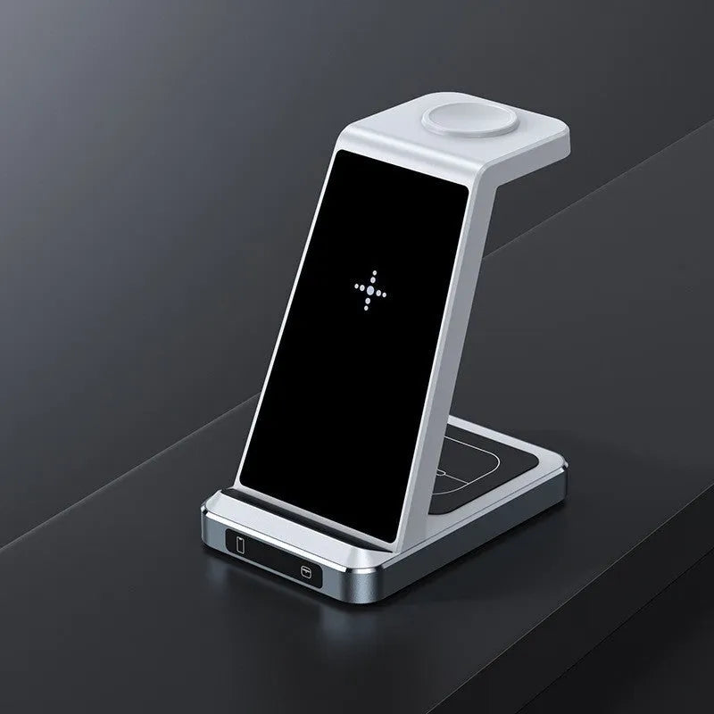 X2 three-in-one wireless charger in black charging a phone, watch, and earbuds on a desk