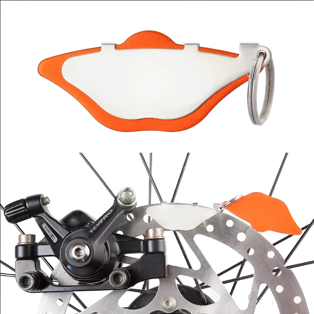 Mountain bike disc brake pad replacement set in black and orange colours with metal construction.