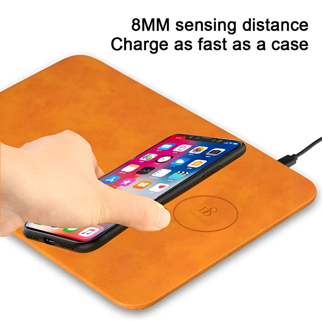 Brown leather-textured wireless charging mouse pad with a Micro USB cable on a wooden desk.