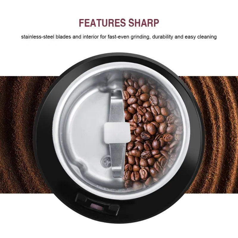 Black or purple mini electric grinder with stainless steel liner on a kitchen worktop