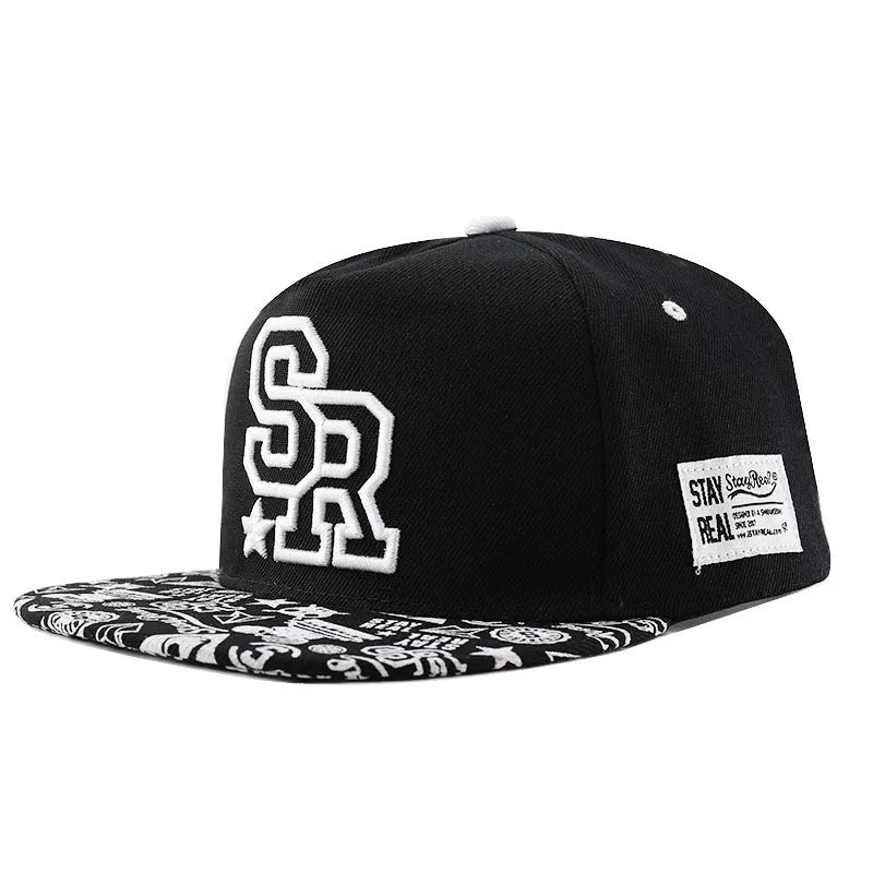 Adjustable black cotton baseball cap with embroidered lettering on the front, showing the dome crown and strap.