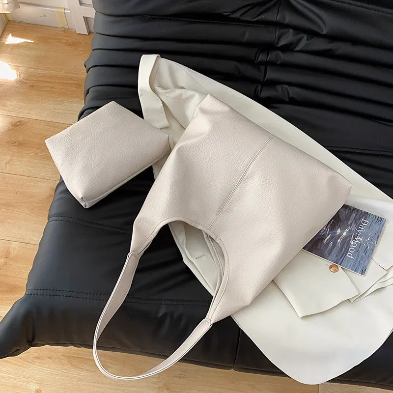 Women's large capacity soft PU shoulder bucket bag with contrast stitching in silver, front view