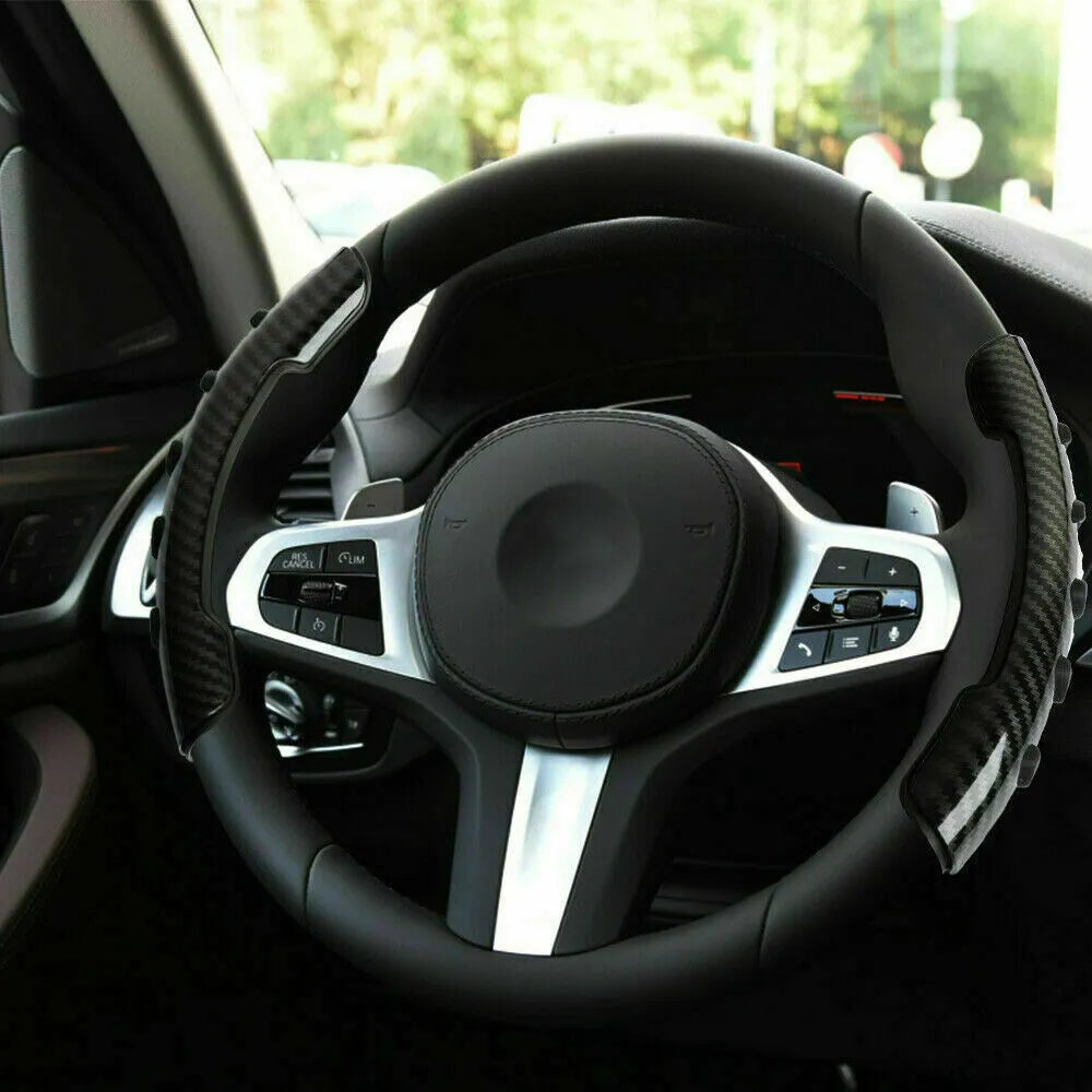Carbon fibre black anti-skid steering wheel sleeve fitted on a car steering wheel.