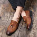 Men's black pointed toe slip-on shoes with a tassel detail on the artificial PU upper.