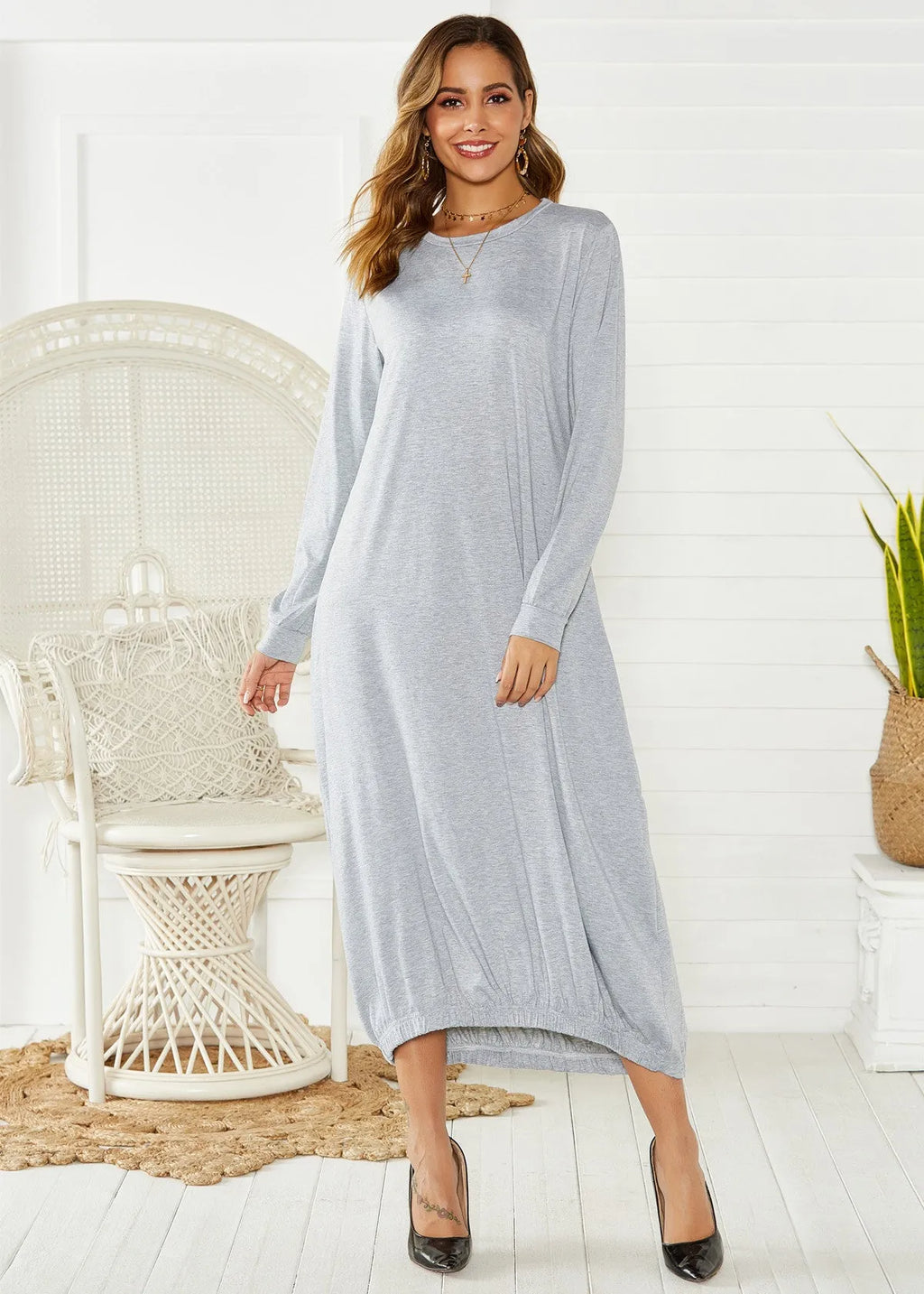 Black lace-up crew neck loose knit lantern dress on a model, showing the lantern silhouette.