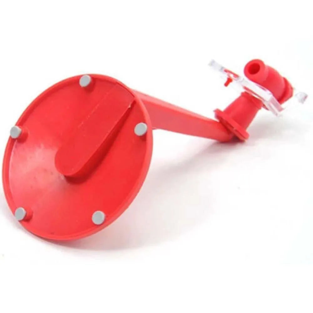 Red Magic Tap plastic soda dispenser attached to an inverted 2-litre bottle on a table.