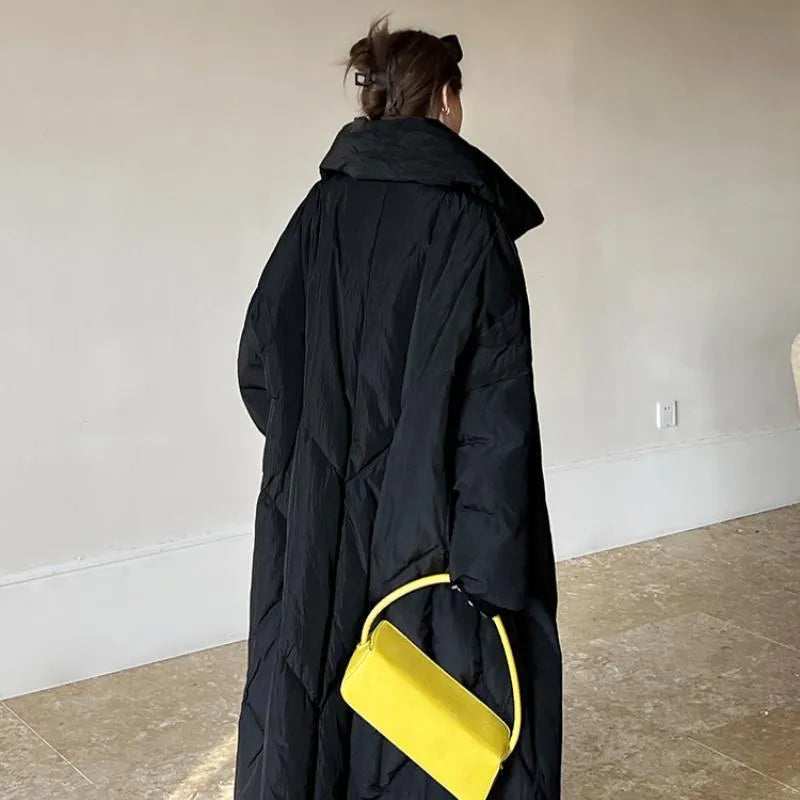 Women's large size mid-length loose fit winter coat with front zipper in black on a model