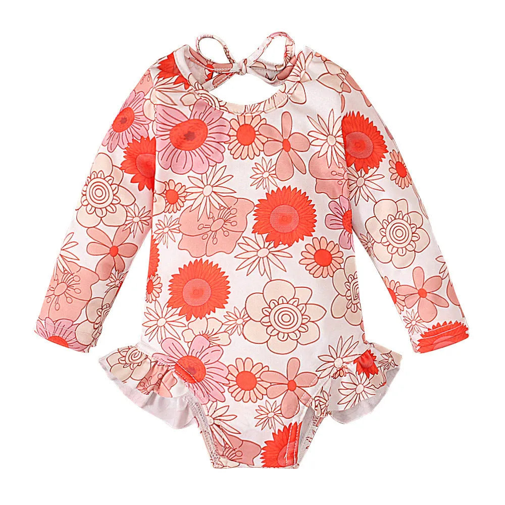 Girl's floral print open back swimsuit in orange, showing crew neck and briefs style.