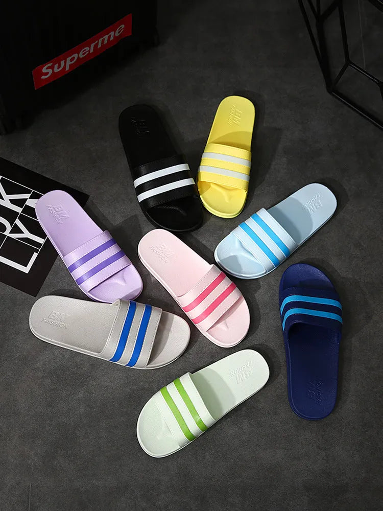 Striped PVC bath slippers for men and women in white with injection-moulded sole, side view