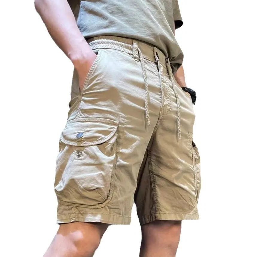 Korean-style loose straight overalls trousers in khaki with multiple pockets and a fifth-pants length above the ankle.