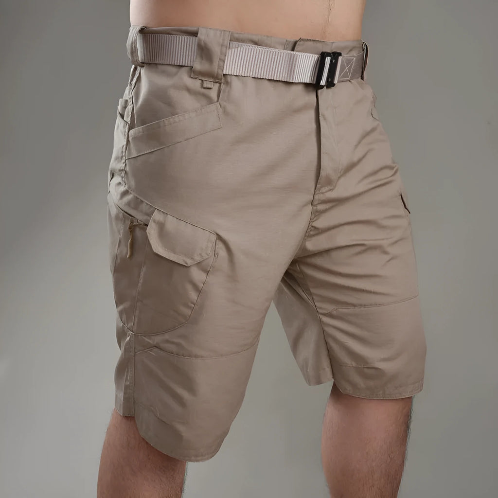 IX7 men's tactical shorts in cotton blend fabric, shown in a camouflage colour with button-fly closure.