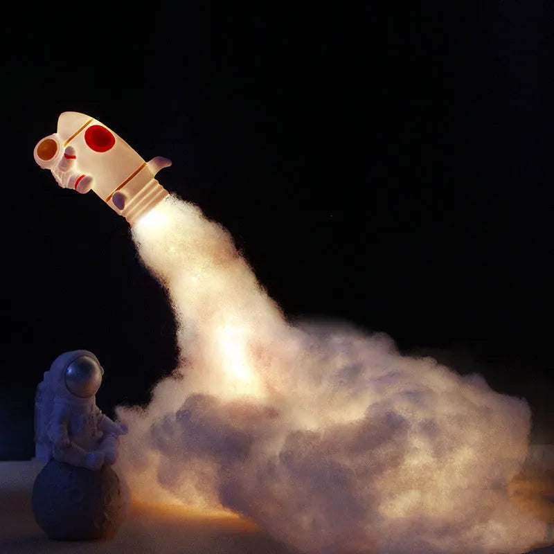 DIY astronaut rocket LED night light kit with battery and USB options, showing model parts and warm glow.