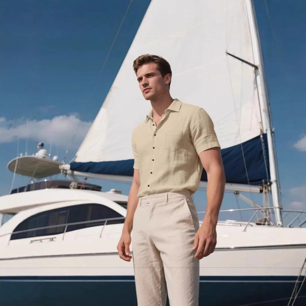 Man wearing a loose-fit grey short-sleeve linen blend shirt for casual leisure.