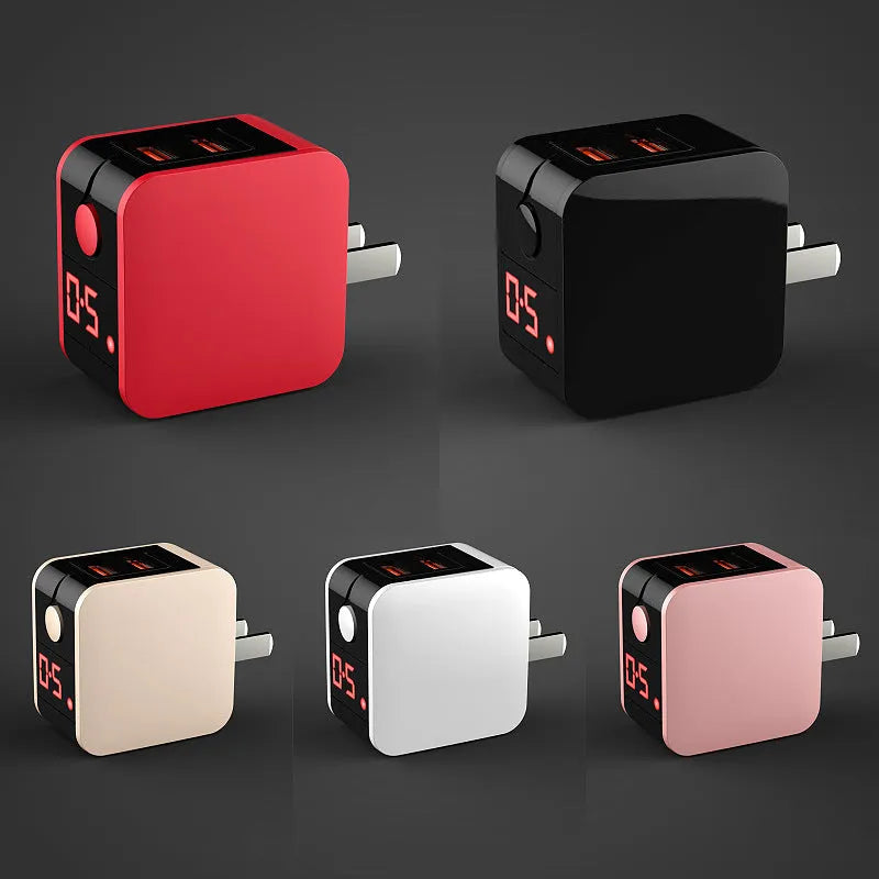 Compact black dual USB travel charger with a digital voltage display showing 5.0V, next to a UK plug.