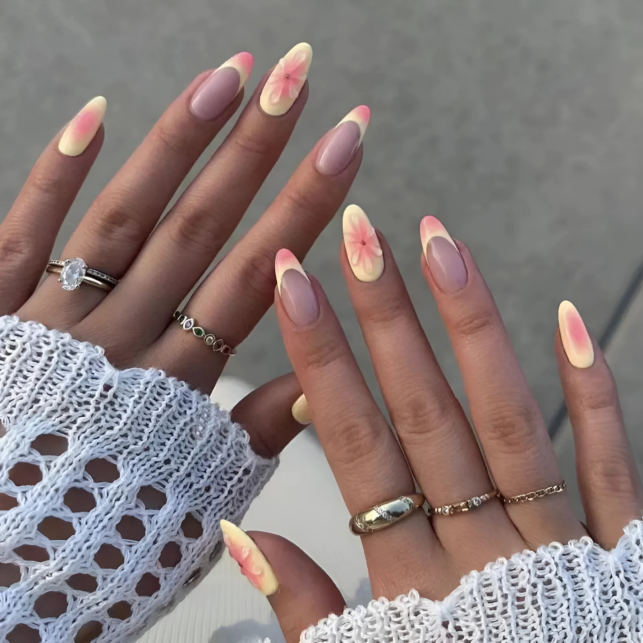Plastic false nails with 3D cartoon flower design, jelly glue, and a nail file strip on a white background.